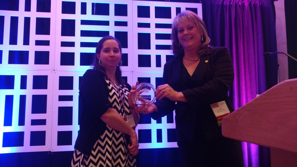 Kathleen Lacey receives an award for the completion of her fellowship with the Michael Schoenecke Fellowship Institute from Lynnea Chapman King, Executive Director of SWPACA.